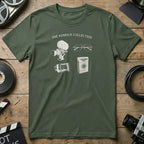Green t-shirt with line drawings of a film camera, glasses, and a book titled "The Kubrick Collection."