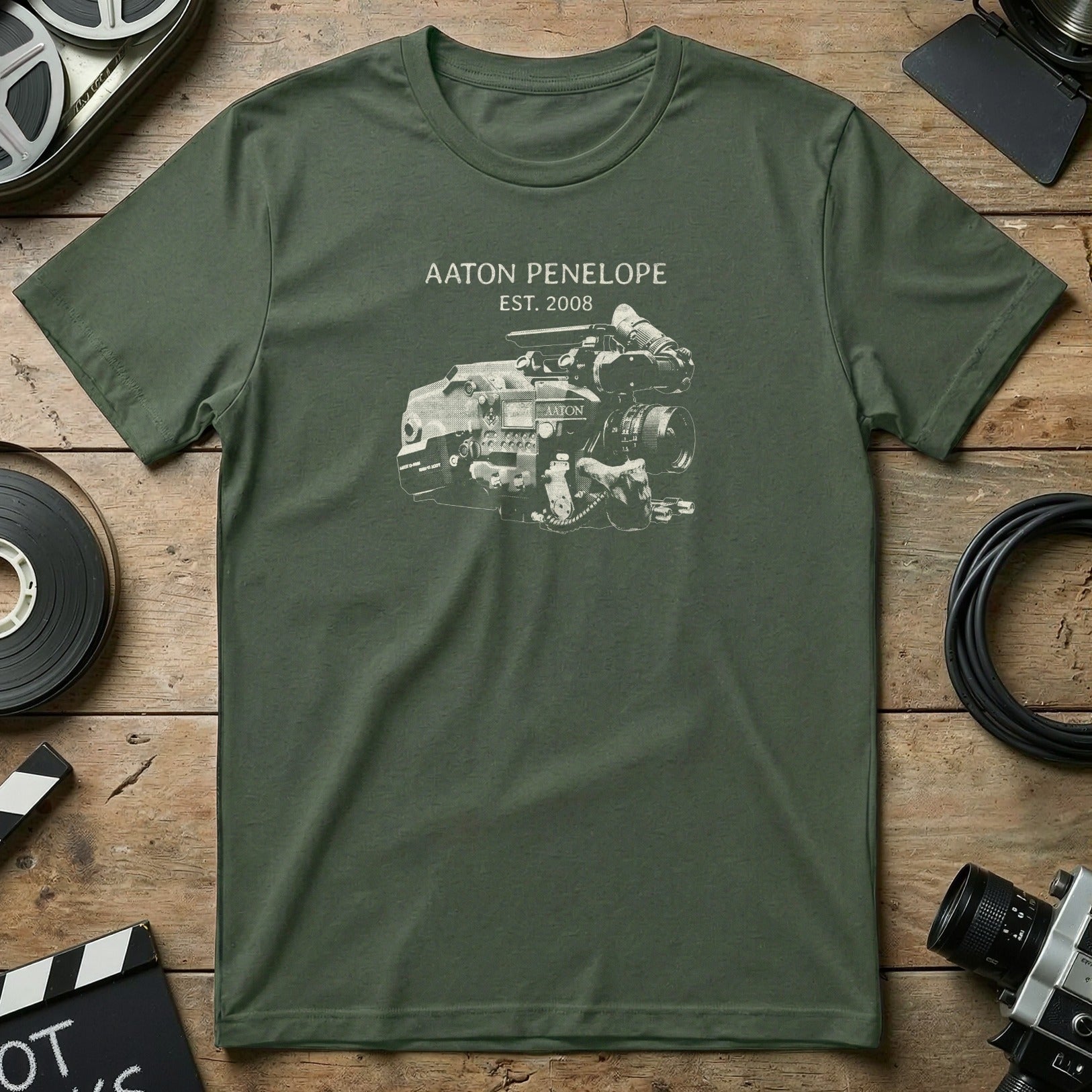 Green t-shirt with "Aaton Penelope EST. 2008" and a drawing of a film camera.