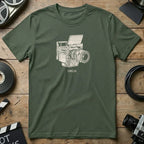 Green t-shirt with white line drawing of a vintage camera and "DRGN" text.