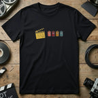 Black t-shirt with film clapperboard and four colorful film canisters with faces.
