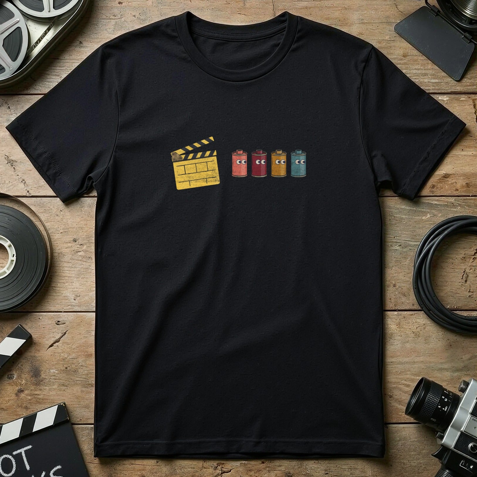 Black t-shirt with film clapperboard and four colorful film canisters with faces.
