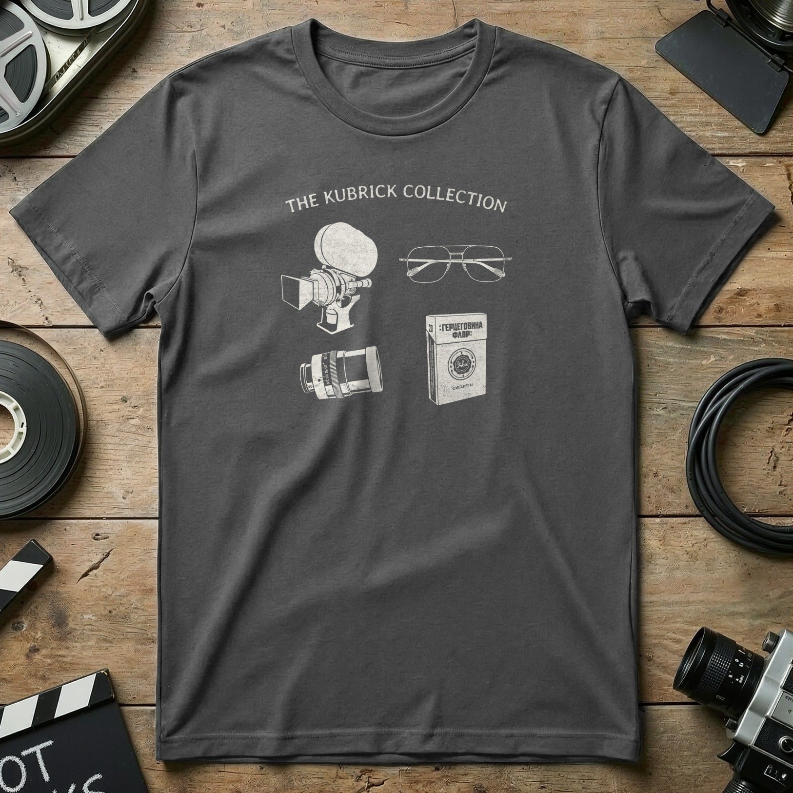 Dark grey t-shirt with line drawings of film equipment and glasses.