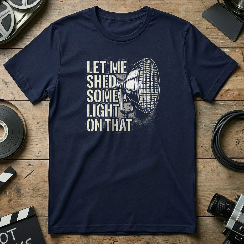 Navy t-shirt with text "Let me shed some light on that" and a spotlight graphic.