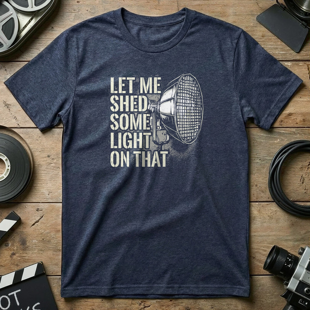 Navy t-shirt with "Let Me Shed Some Light On That" text and a spotlight graphic.