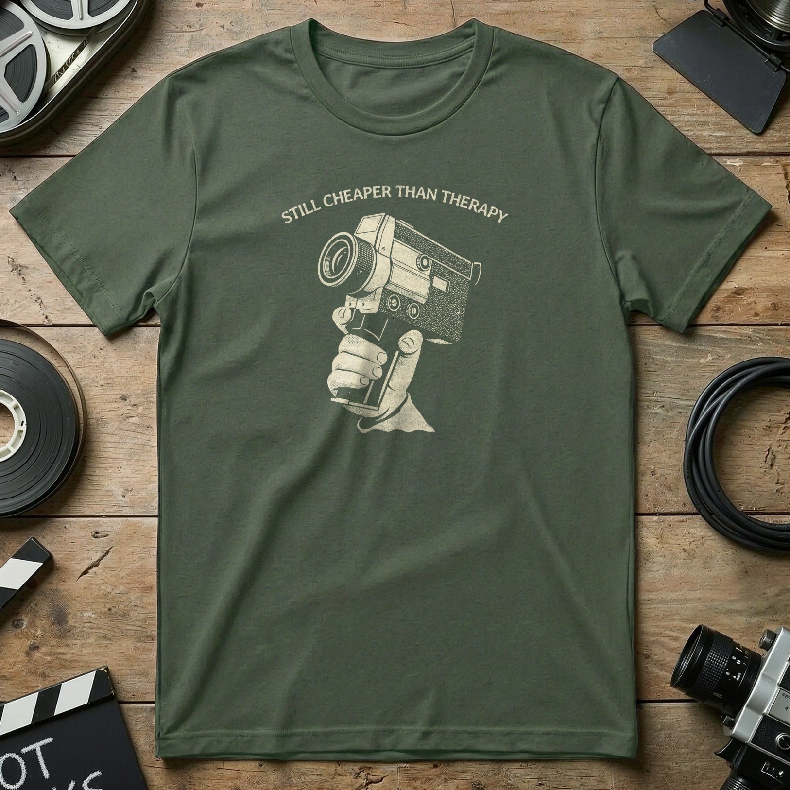 Olive green t-shirt with graphic of a hand holding an old film camera.