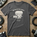 Dark grey t-shirt with "MOTION PICTURE CAMERA - SUPER PSR - EST. 1967" graphic.