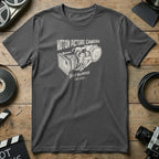Dark grey t-shirt with vintage film camera graphic and "Motion Picture Camera Self Blimped EST. 1975" text.