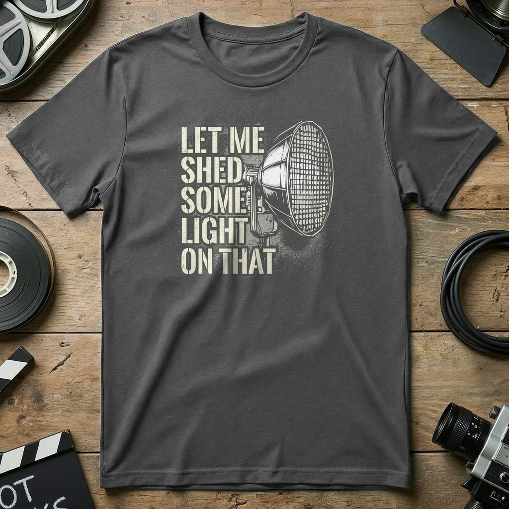 Gray t-shirt with "Let me shed some light on that" and spotlight graphic.