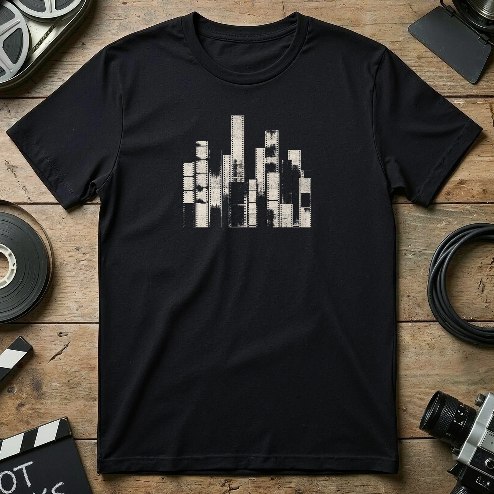 Black t-shirt with abstract film reel city skyline design.