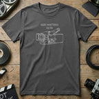 Dark grey t-shirt with white line drawing of vintage video camera and text "Size Matters 15/70".