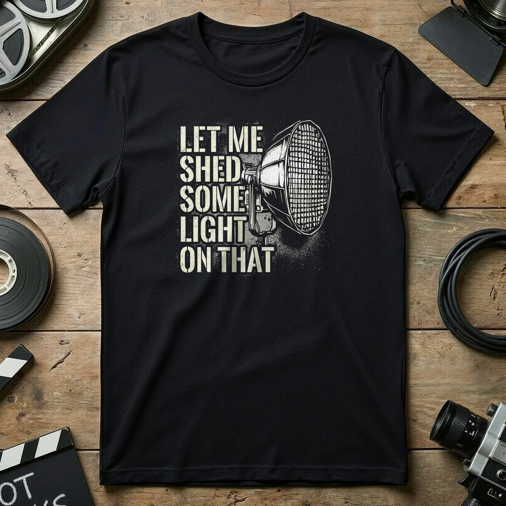 Black t-shirt with "Let Me Shed Some Light On That" and a graphic of a spotlight.
