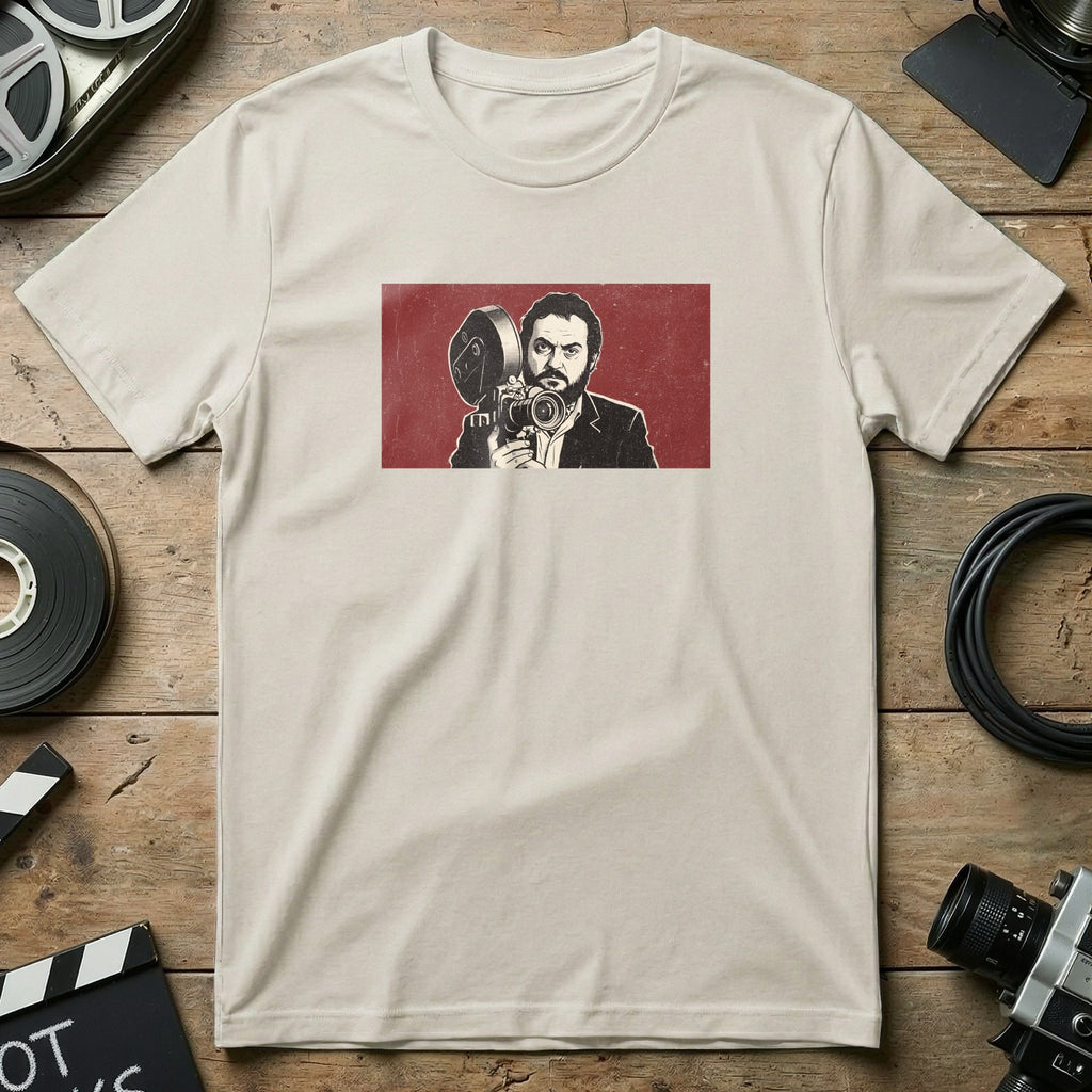 Stanley Kubrick holding a vintage film camera on a cream t-shirt.