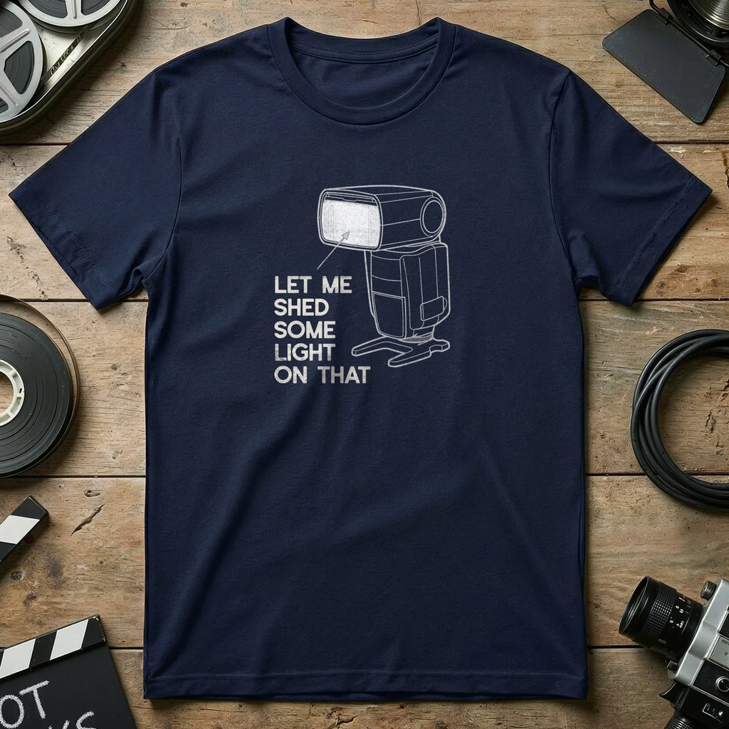 Navy t-shirt with white graphic of a camera flash and text "Let me shed some light on that."