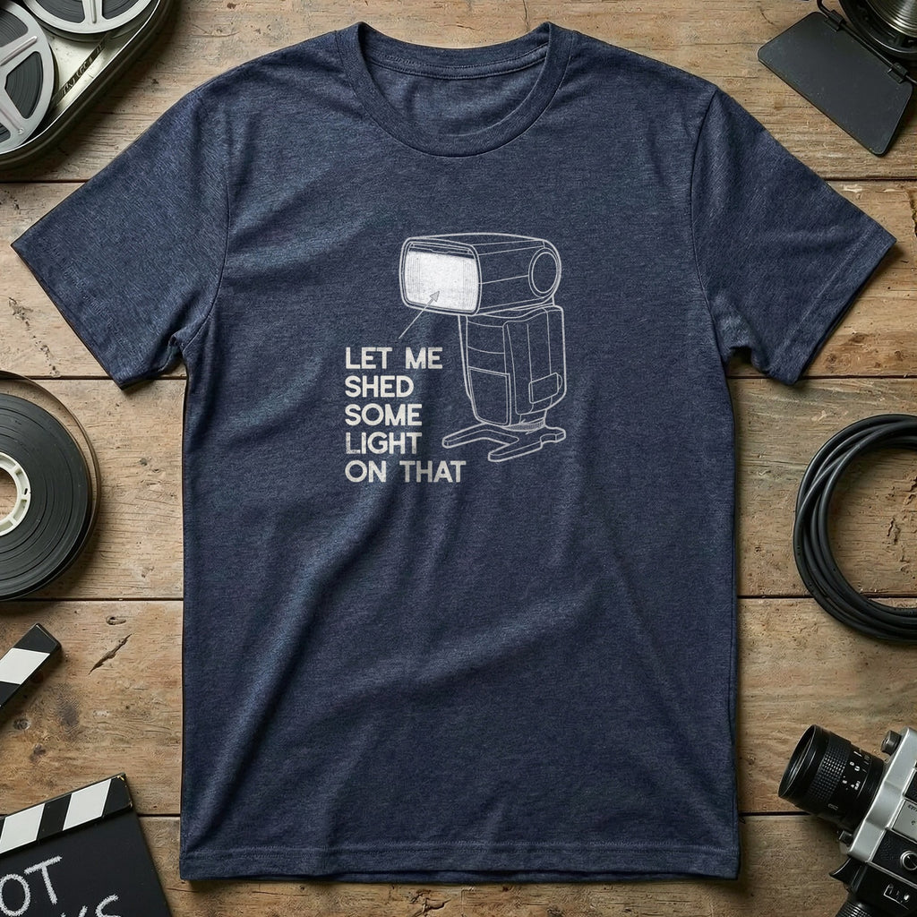 Navy t-shirt with graphic of camera flash and text "LET ME SHED SOME LIGHT ON THAT".