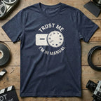 Navy t-shirt with "TRUST ME I'M IN MANUAL" and a camera dial graphic.